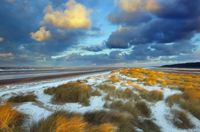 Sunset on Holkham Beach with a dusting of snow, Norfolk, England, UK, January 2010.