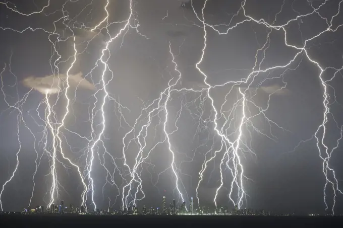 Lightning strikes above skyscrapers on Gold Coast coastline, composite image of strikes over a twenty minute period. Queensland, Australia. 2018.
