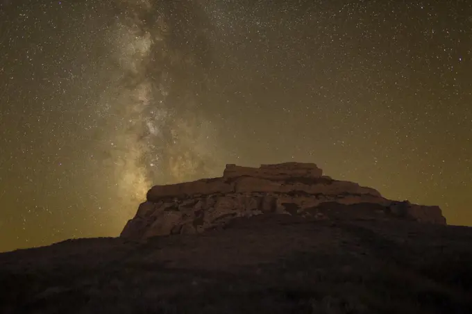 Courthouse rock at night with an arm of The Milky Way galaxy visible in the sky. Near Bridgeport, Nebraska, USA, September.