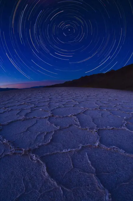 Star trail over Badwater Salt Flats, Death Valley National Park, California. August 2008. Taken with multiple long exposures and fish eye lens.