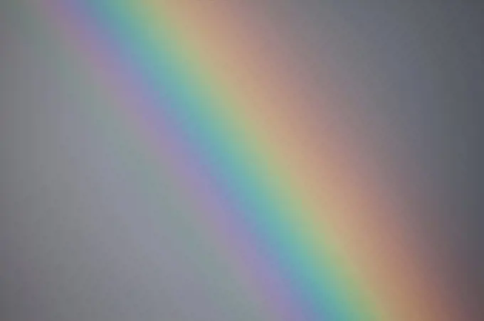 Detail of rainbow including subspectrum colours inside the violet band. Peak District National Park, Derbyshire, UK, May.