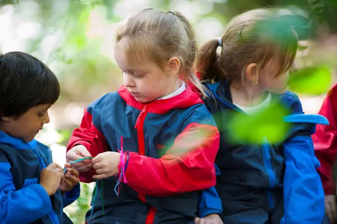 Children from Rowley View Nursery School exploring nature at the Moorcroft Environmental Centre Forest School, Moorcroft Wood, Moxley, Walsall, West Midlands, July 2011. Model released.