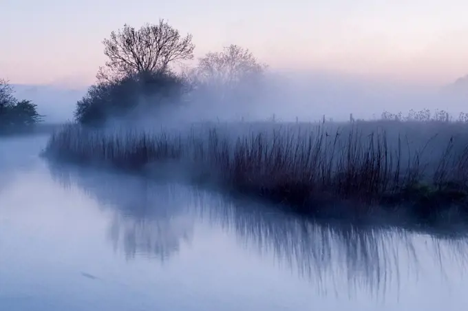 River Stour with early morning mist and frost, near Wimborne Minster, Dorset, UK. April 2012.