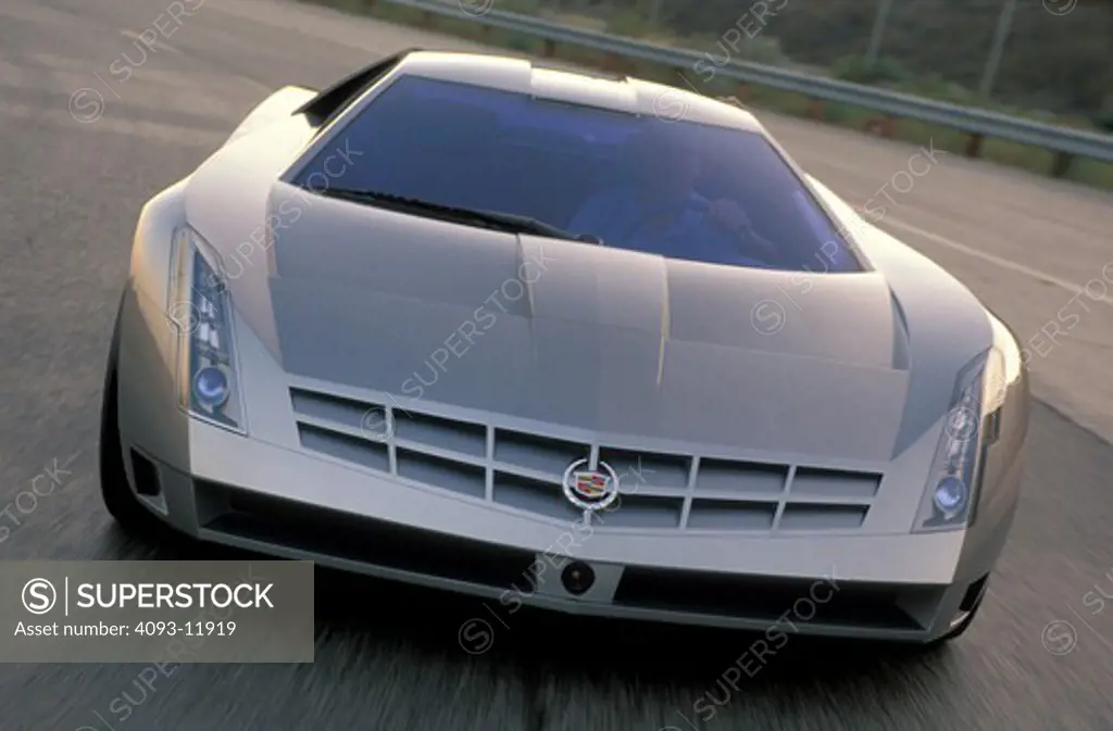 Cadillac Cien concept show car prototype silver front nose asphalt pavement man curve cornering guard rail head on street