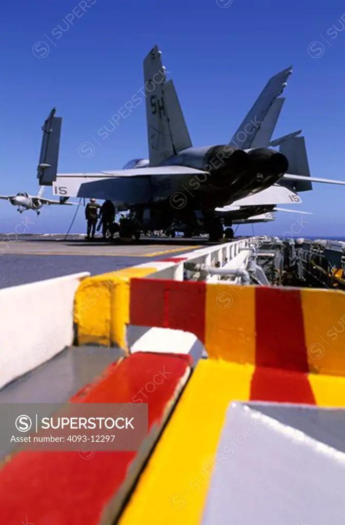 low angle Military Jets Fixed Wing Boeing Aviat Airplanes FA-18 Hornet grey flight deck aircraft carrier red yellow stripes