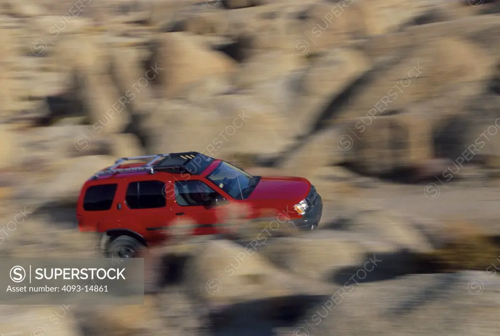 Nissan 2000 Xterra overhead profile rocks red off road rack blur