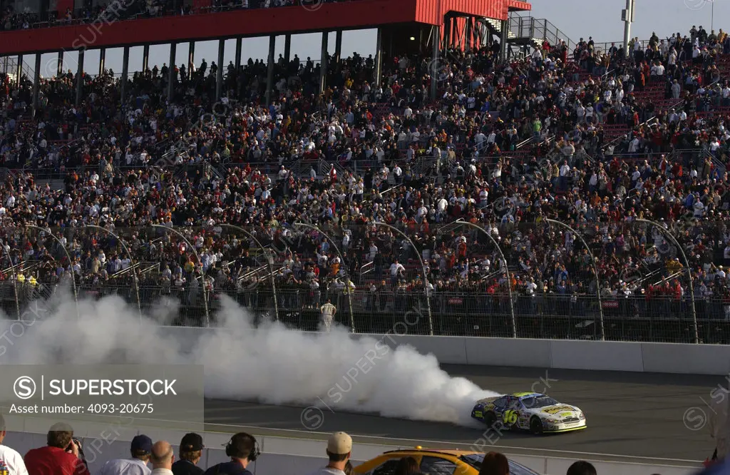 NASCAR burnout tire smoke grandstands crowd