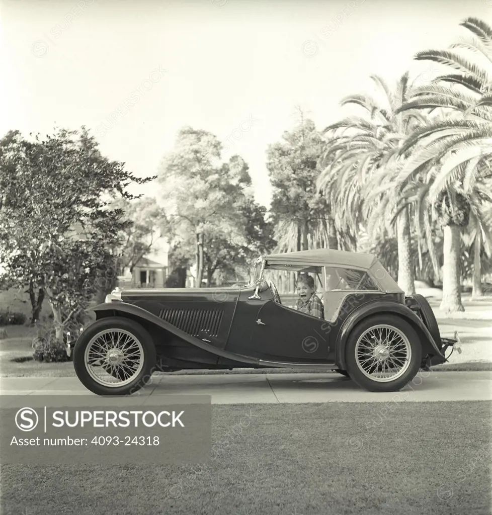 MG TC 1949 1940s boy kid driveway Los Angeles period nostalgia street city