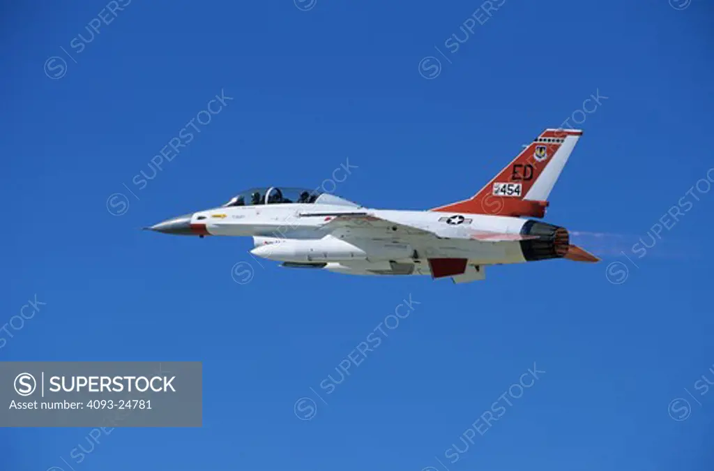 USAF F-16B (two-seat) of the USAF Flight Test Center at Edwards AFB takes off from Edwards. The aircraft carries a distinct white and orange paint scheme and ED code on the tail distinguishing it as an Edwards based aircraft.