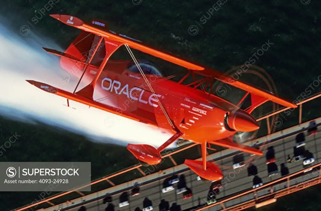 Sean D Tucker in the Oracle Challenger aerobatic biplane over the Golden Gate Bridge  San Francisco  CA