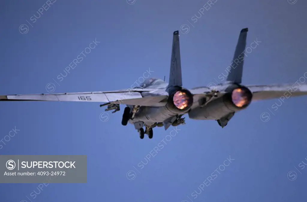 Tight tail view takeoff shot of a US Navy Grumman F-14 Tomcat of VF-101 Grim Reapers carrying two laser guided training round bombs in full afterburner