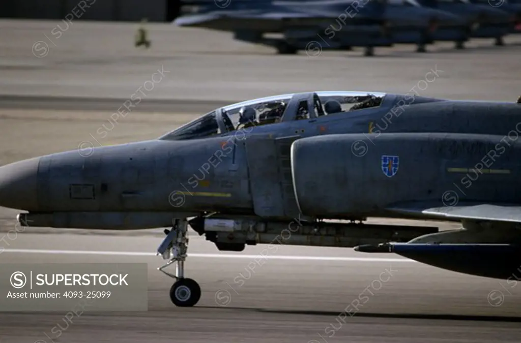 On the runway, a German Air Force (Luftwaffe) McDonnell F-4 Phantom II rolls out after landing