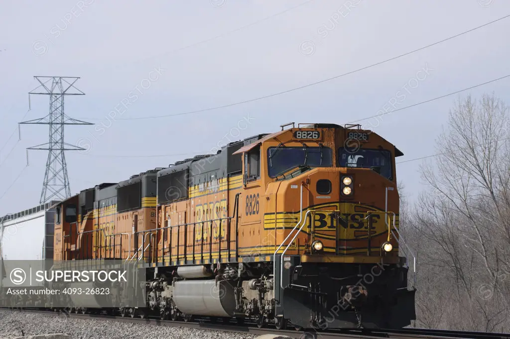 BNSF8826 Mixed Manifest train, General Motors EMD SD70MAC, two engine consist, eastbound, MP126. rural setting, electric transmission towers