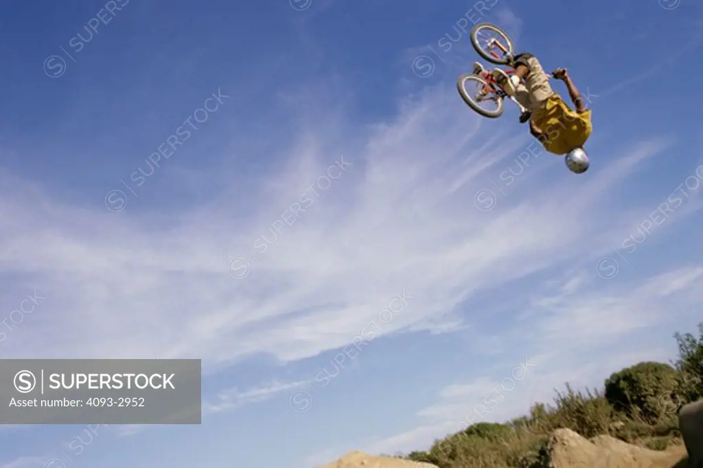 BMX jumping airborne sky upside-down flipping