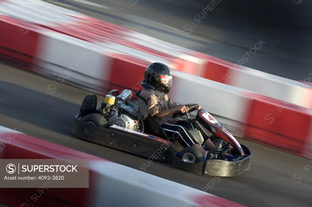 Go Kart racing on a track, side view