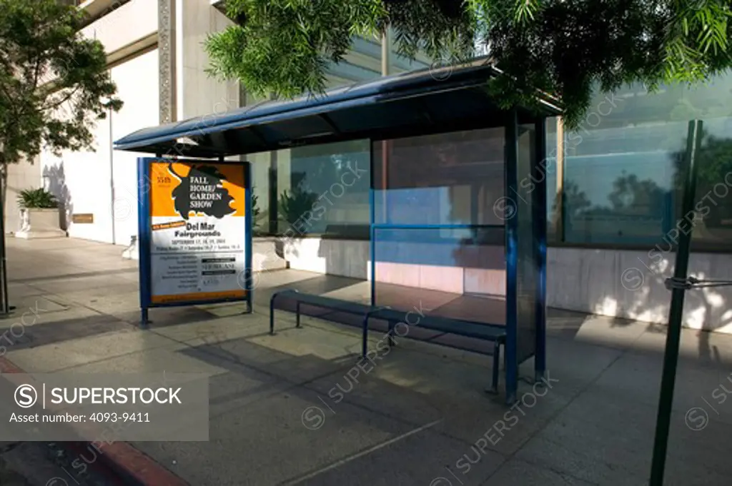 bus stop bus shelter advertisement sidewalk city - SuperStock