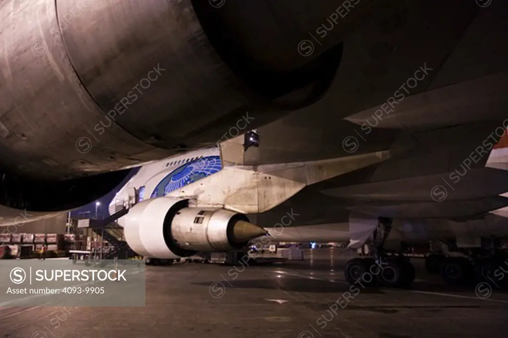 Northwest Airlines Boeing 747 200 freighter at LAX airport. View looking forward towards nose of the aircraft underneath the wing. Showing both left side jet engines.