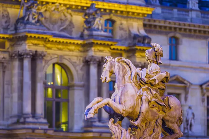 Louvre Museum courtyard with statue at dusk, Paris