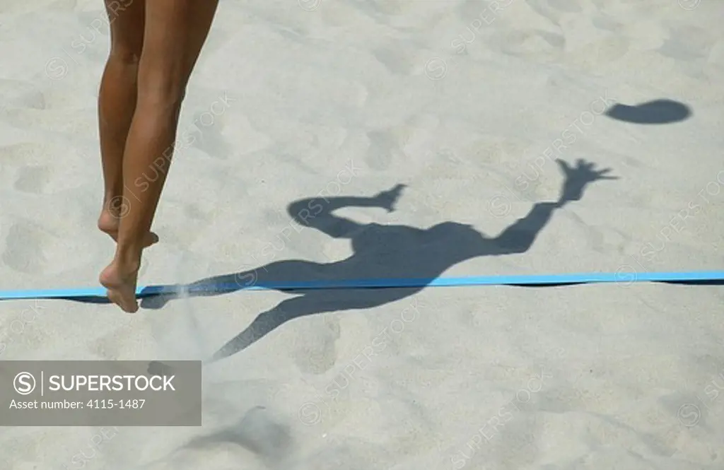 Legs and shadow of a player during the Germany versus Bulgaria beach volleyball match, Olympic Games, Athens, Greece, 16 August 2004.