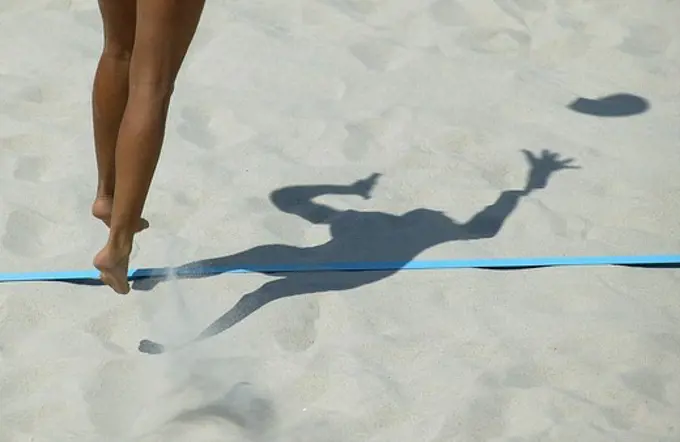 Legs and shadow of a player during the Germany versus Bulgaria beach volleyball match, Olympic Games, Athens, Greece, 16 August 2004.