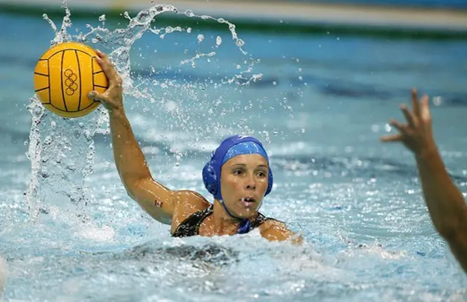 A player takes on her opponent at a women's water polo match, Olympic Games 2004, Athens, Greece.