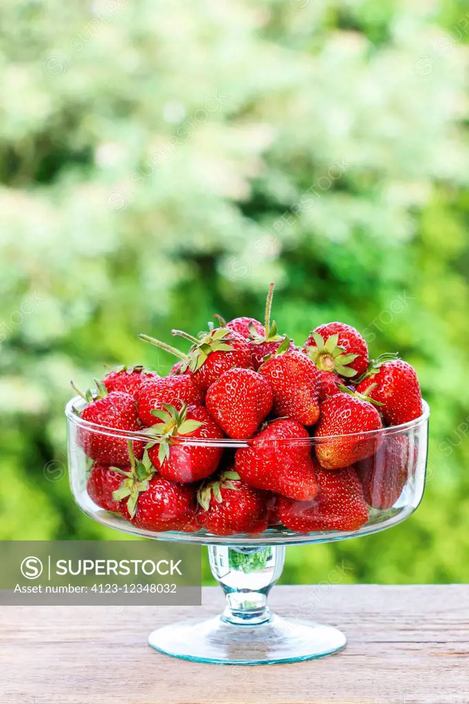 Fresh ripe strawberries in glass bowl