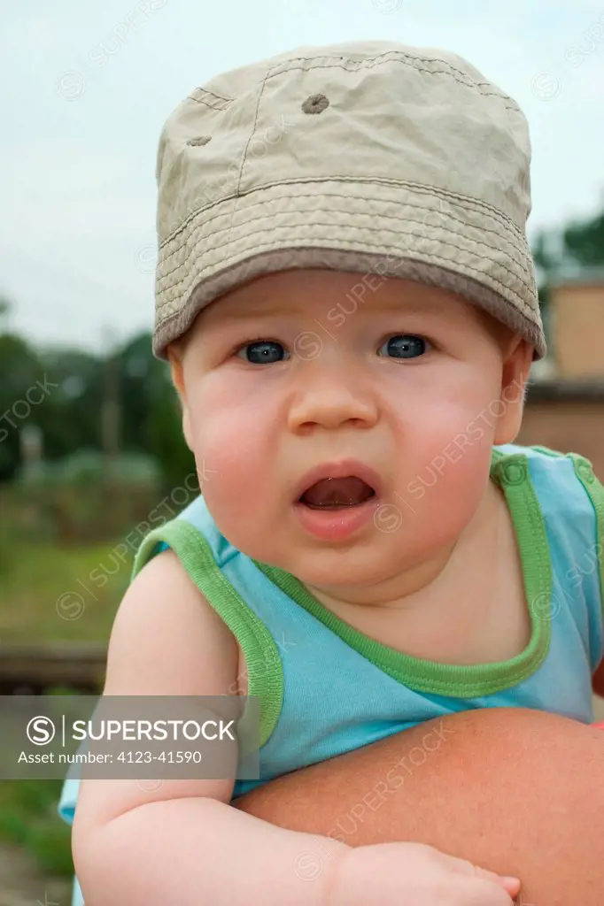 Baby being held by its parent.