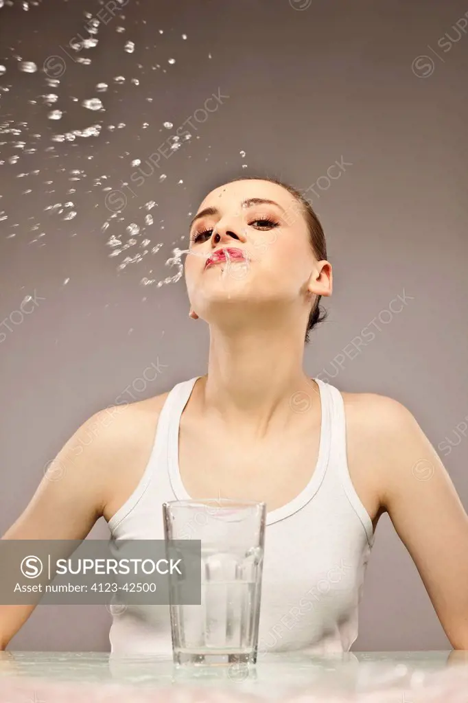 Woman spitting out water.