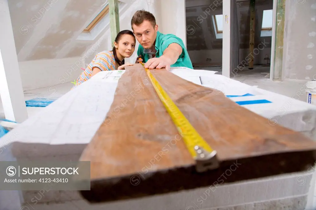 Young people measuring desk.