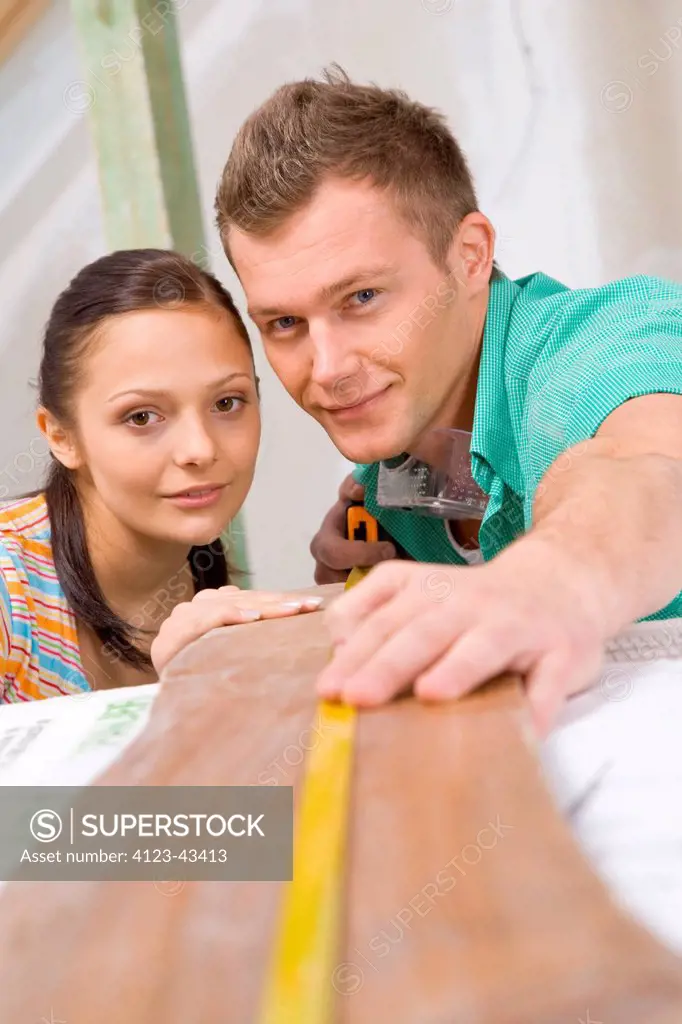 Young people measuring desk.