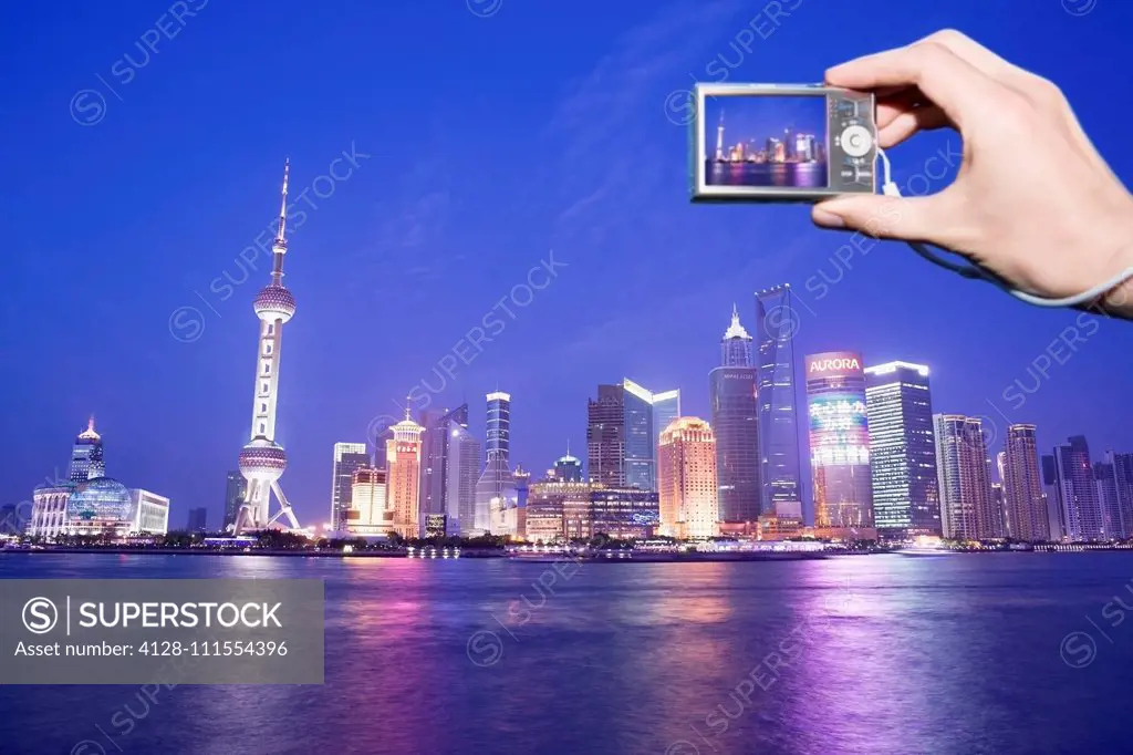 Tourist photographing Shanghai skyline, China