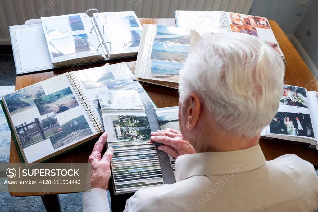 Senior man looking at photo albums