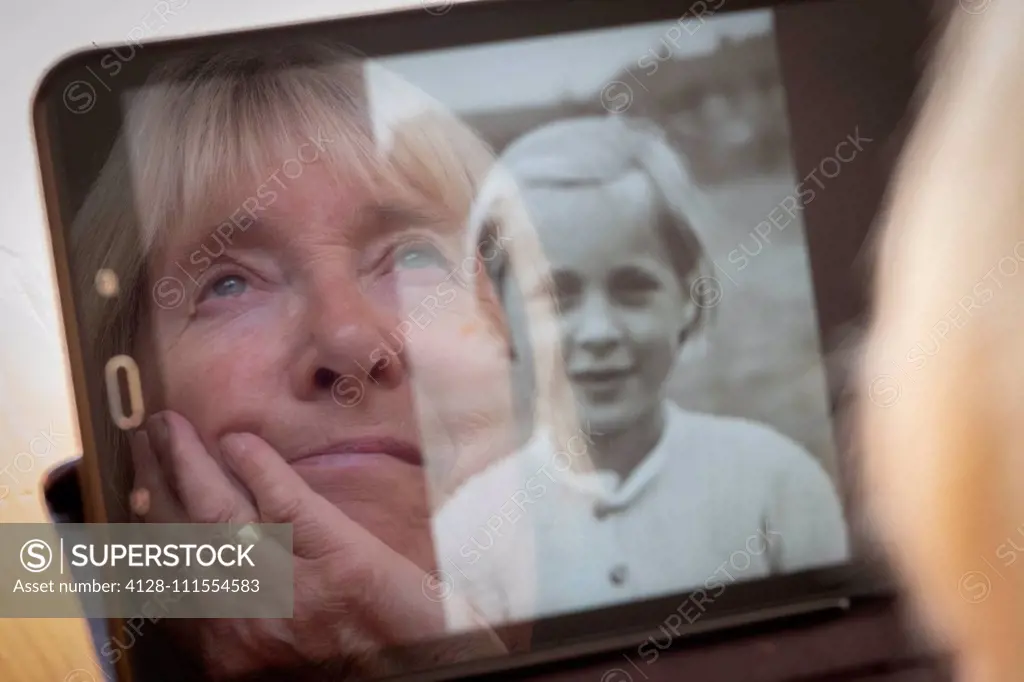 Senior woman looking at her younger self