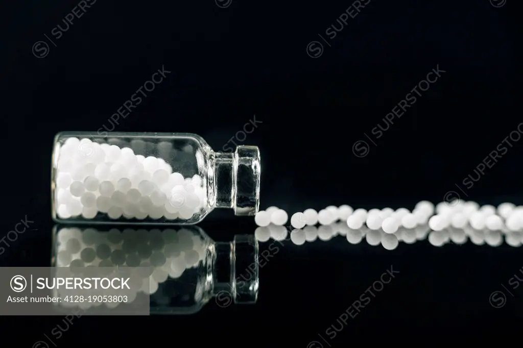 Homeopathic globules scattered out of glass bottle