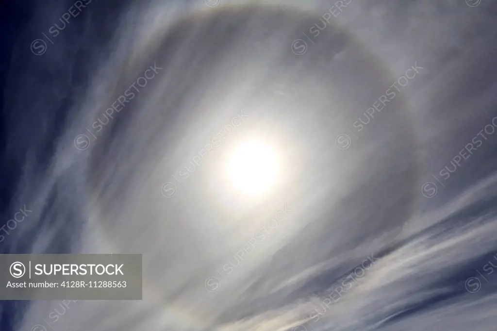 Cirrus cloud formation and ice halo, Antarctica. The halo is a phenomenon, caused by the refraction of sunlight through tiny hexagonal ice crystals in...