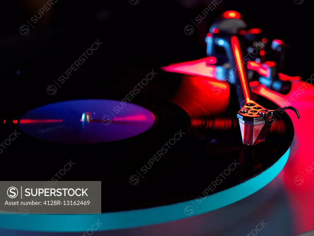 Close up of a stylus playing a vinyl record.