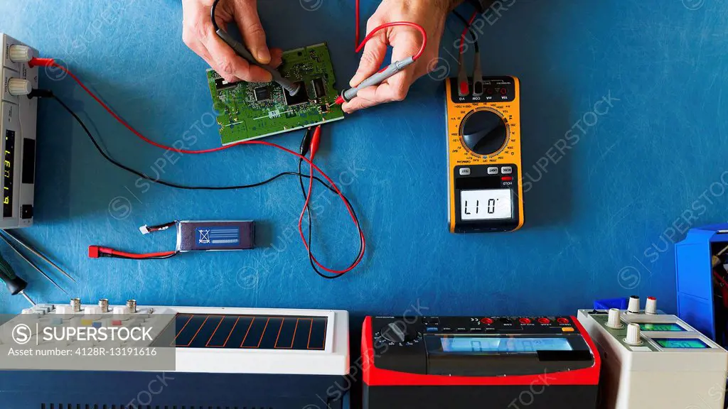 Person working with electronic measuring instruments.