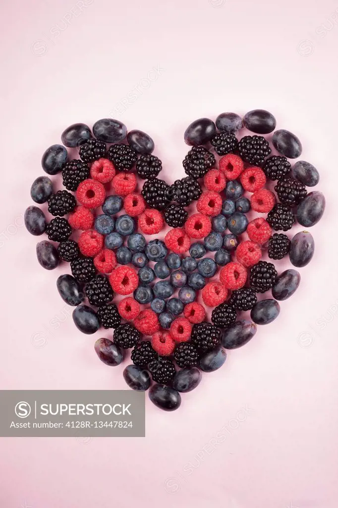 Fresh berries in heart shape, studio shot.