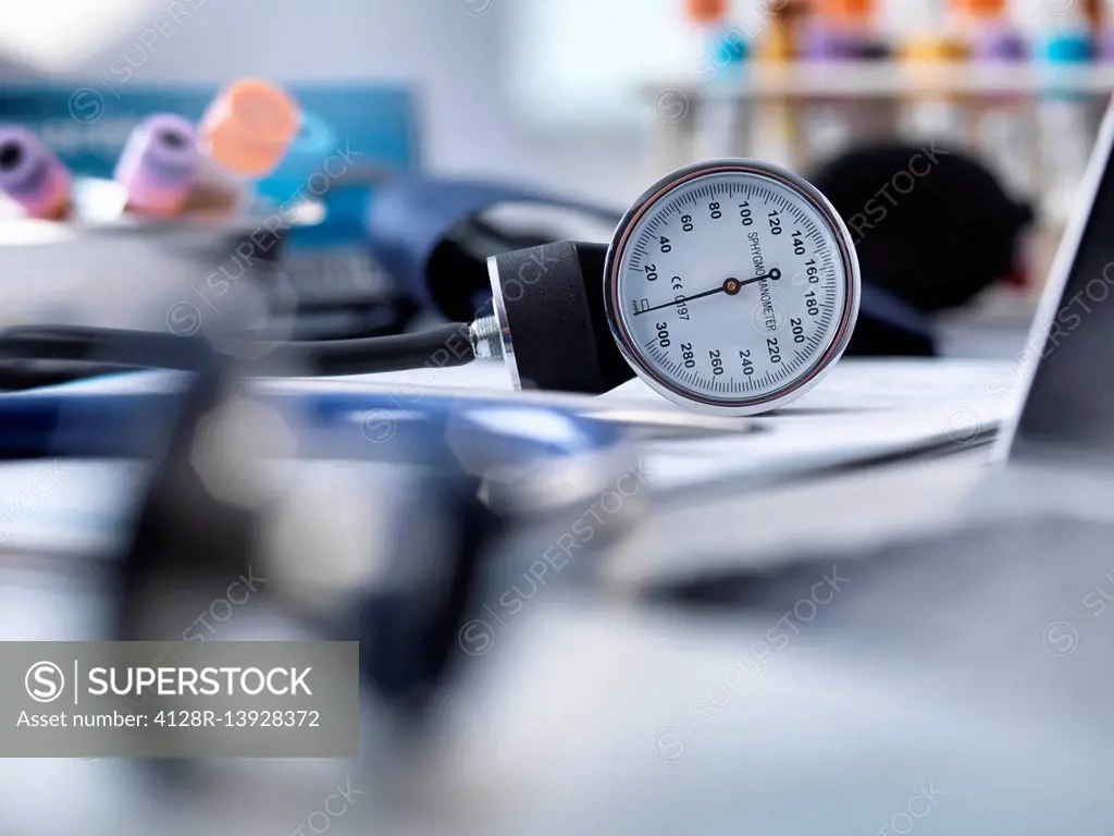 Blood pressure gauge, stethoscope and human samples awaiting medical testing.