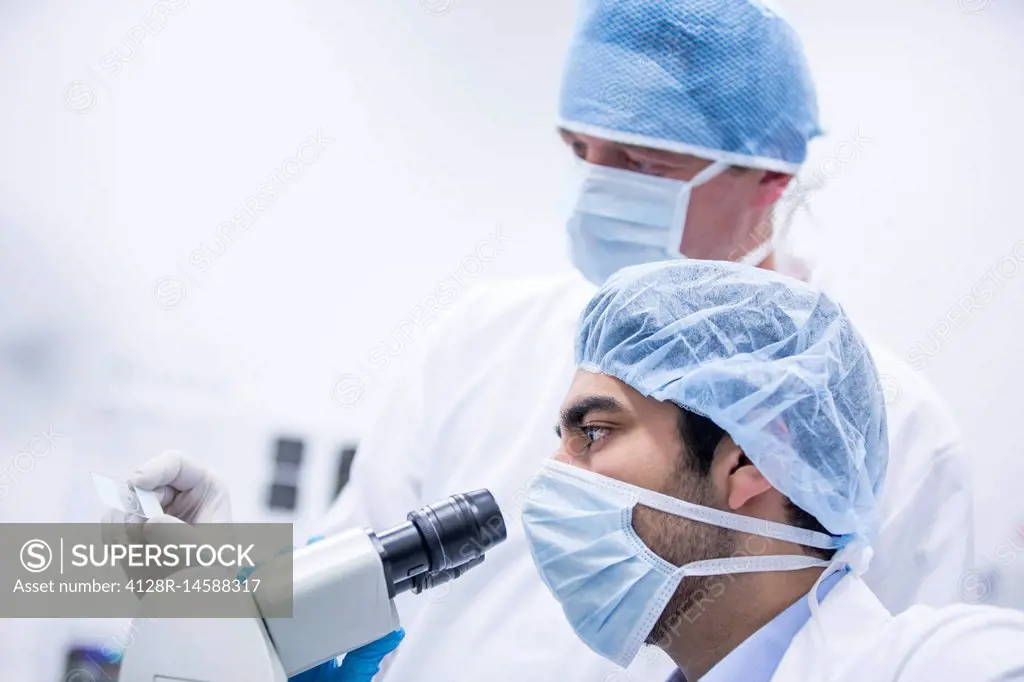 Scientist using microscope