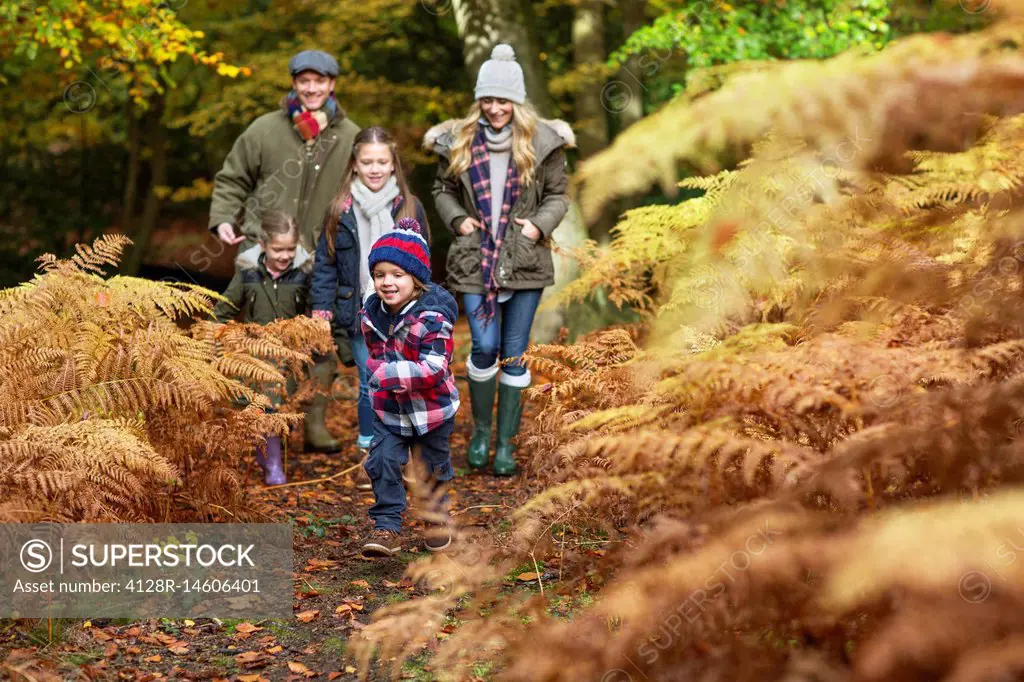 Family walking in woods in Autumn