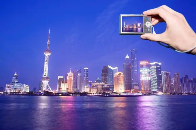 Tourist photographing Shanghai skyline, China