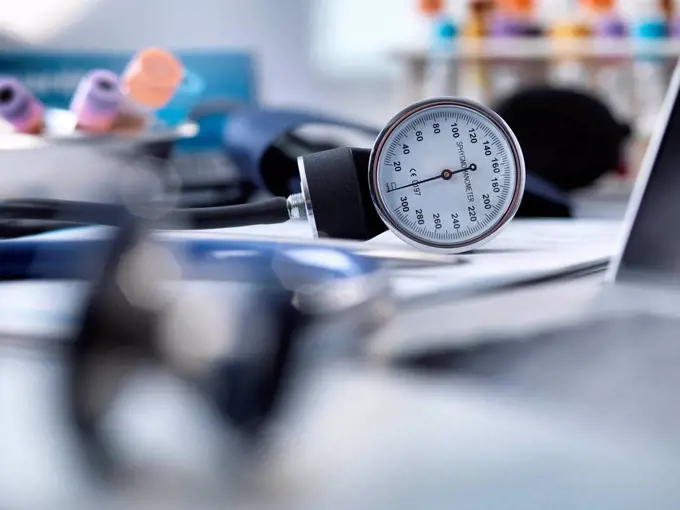 Blood pressure gauge, stethoscope and human samples awaiting medical testing.