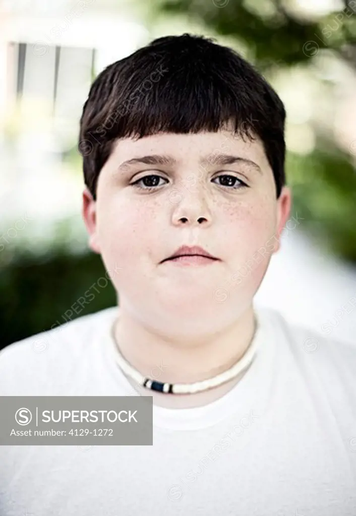 Close-up portrait of overweight teenage boy