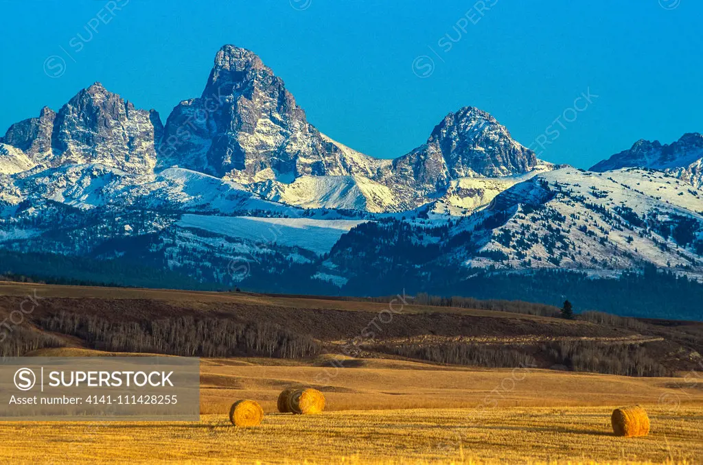 Teton Mountain Range from near Ashton, Idaho. Alpine Wilderness creates a stunning backdrop to cultivation and agriculture