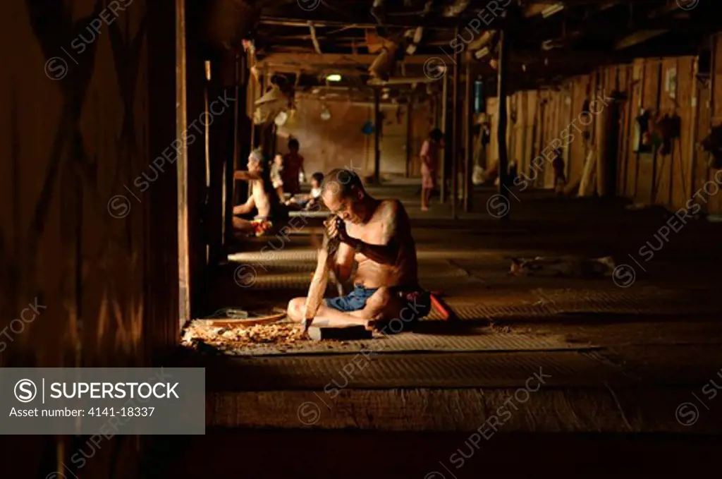 iban man wood carving sabah, borneo, malaysia