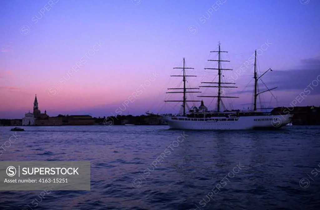 ITALY, VENICE, CANAL DELLA GIUDECCA, CRUISE SHIP SEA CLOUD II AT SUNSET.