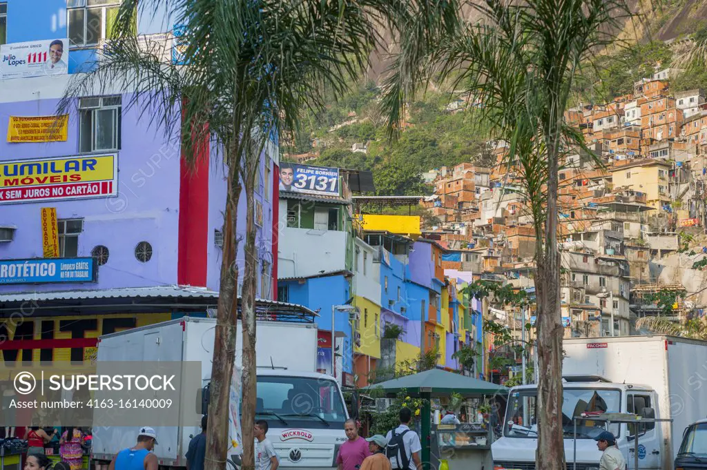 Street scene with colorful painted houses in the Rocinha favela, the largest favela in Brazil, in Rio de Janeiro, Brazil.