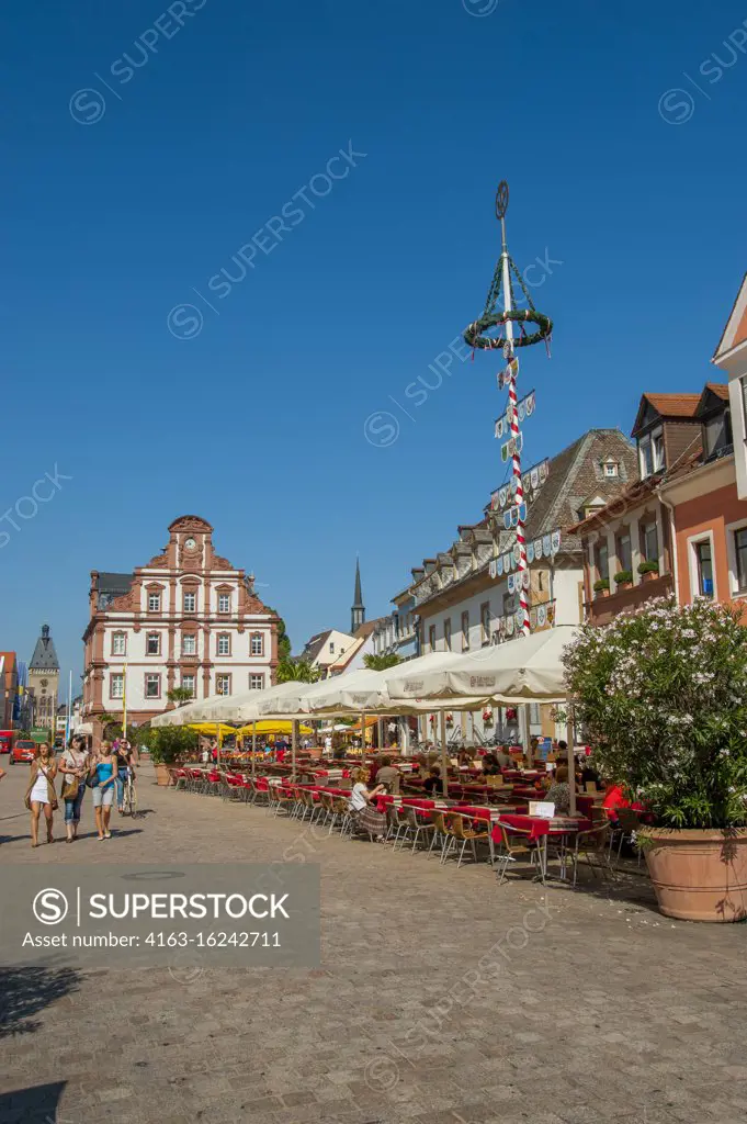 The market place with sidewalk restaurants and the old Mint on the Maximilian Street in Speyer, a town on the Rhine River in Germany.