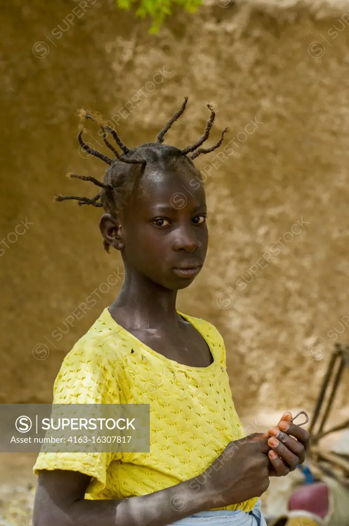 Portrait of a teenage girl with an interesting hairstyle in Segoukoro village (Bambara tribe) near Segou city in the center of Mali, West Africa.